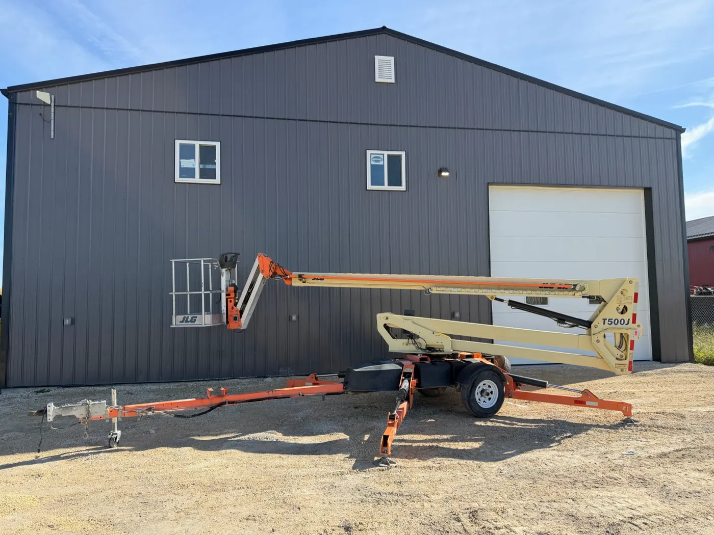 JLG towable boom lift folded down on its trailer