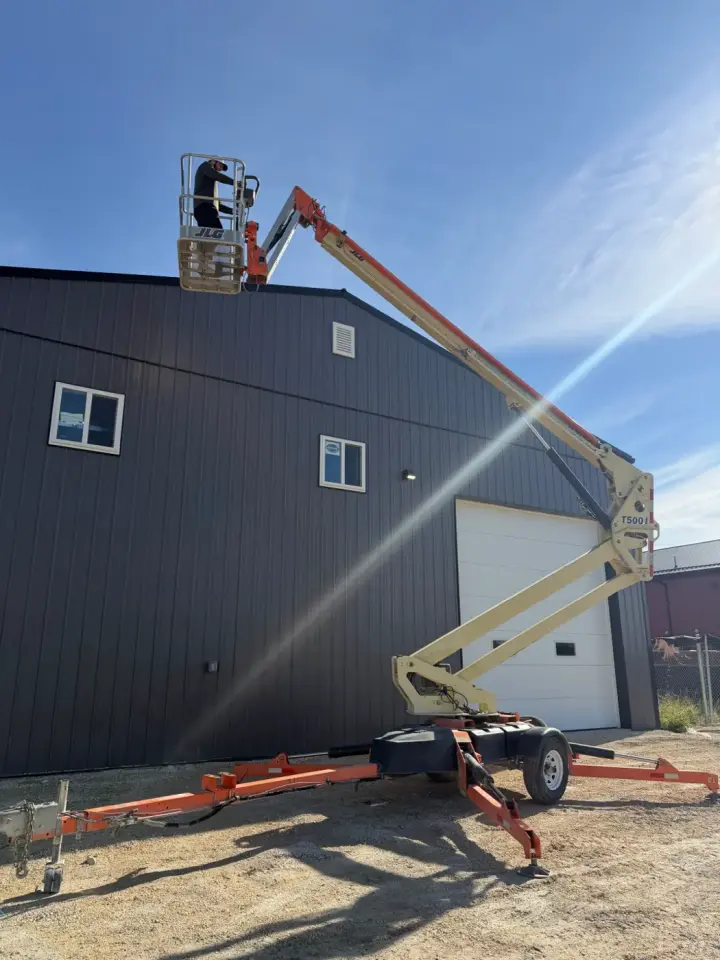 JLG towable boom lift folded down on its trailer